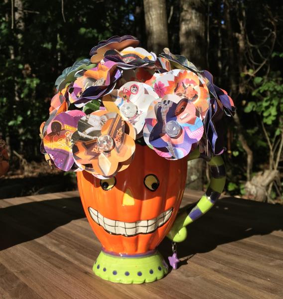 Coco little golden book hand-cut paper flower arrangement in smiling pumpkin mug picture