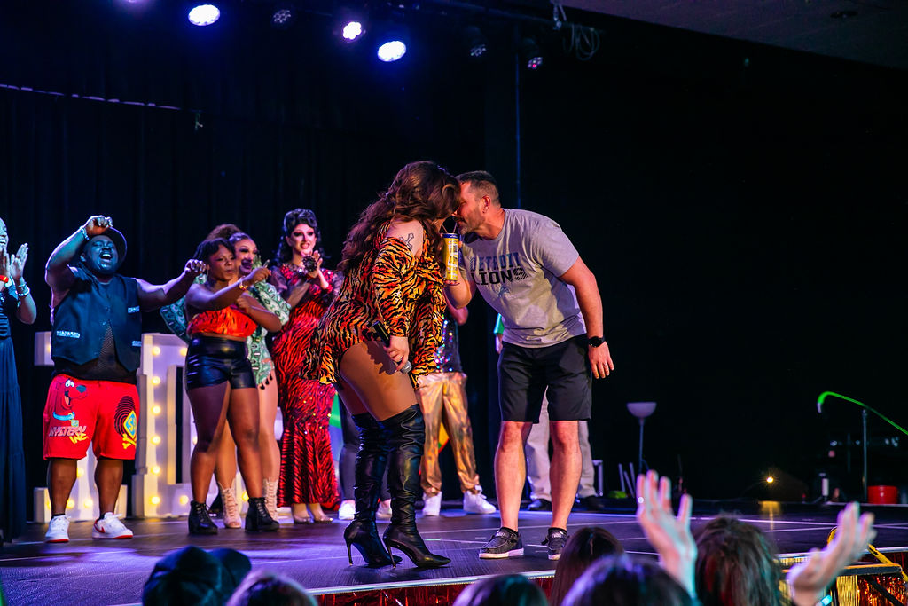 Host of Pride After Party Drag Show playfully butting heads with attendee in impromptu moment on stage