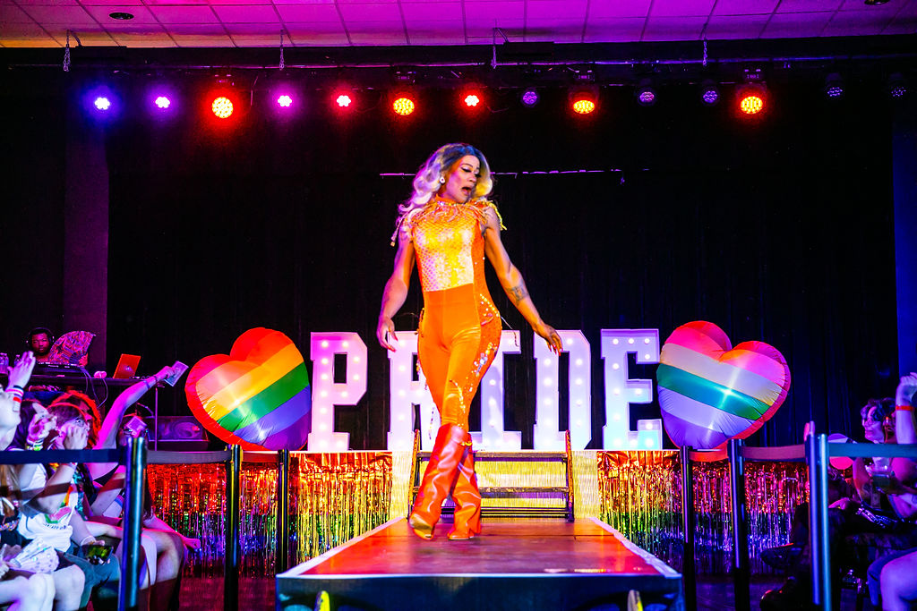 Pride After Party Drag Show drag performer walking sultrily to the end of the stage catwalk