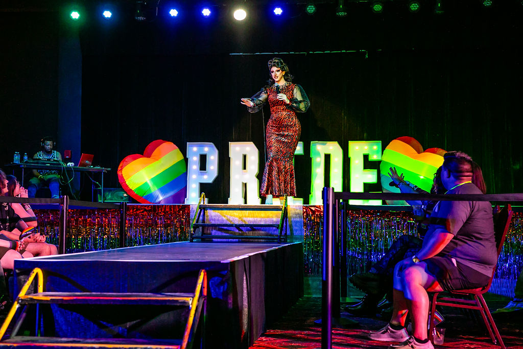 Pride After Party Drag Show drag performer singing live on stage.