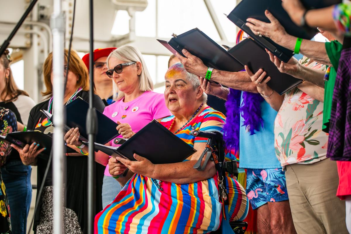 Three Harmony Diversity Choir members performing at the Great Lakes Bay Pride Festival