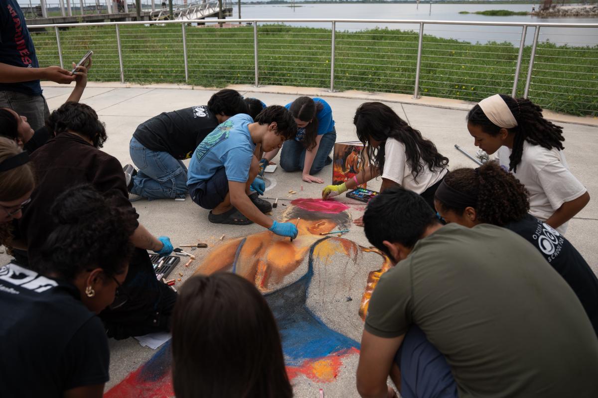 Osceola School of the Arts - Students completing sidewalk Chaulk art.
