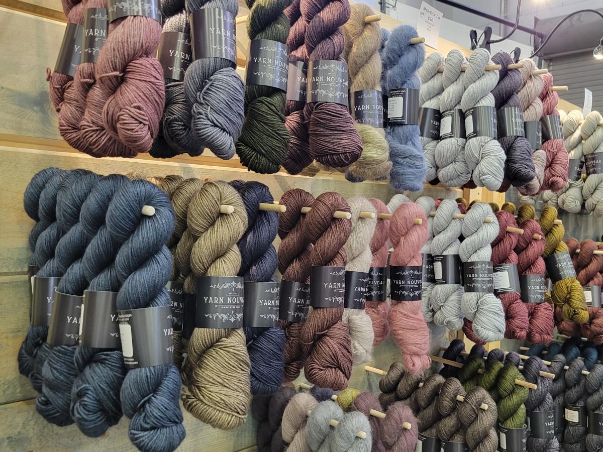 display of multi-colored hanks of yarn in a booth
