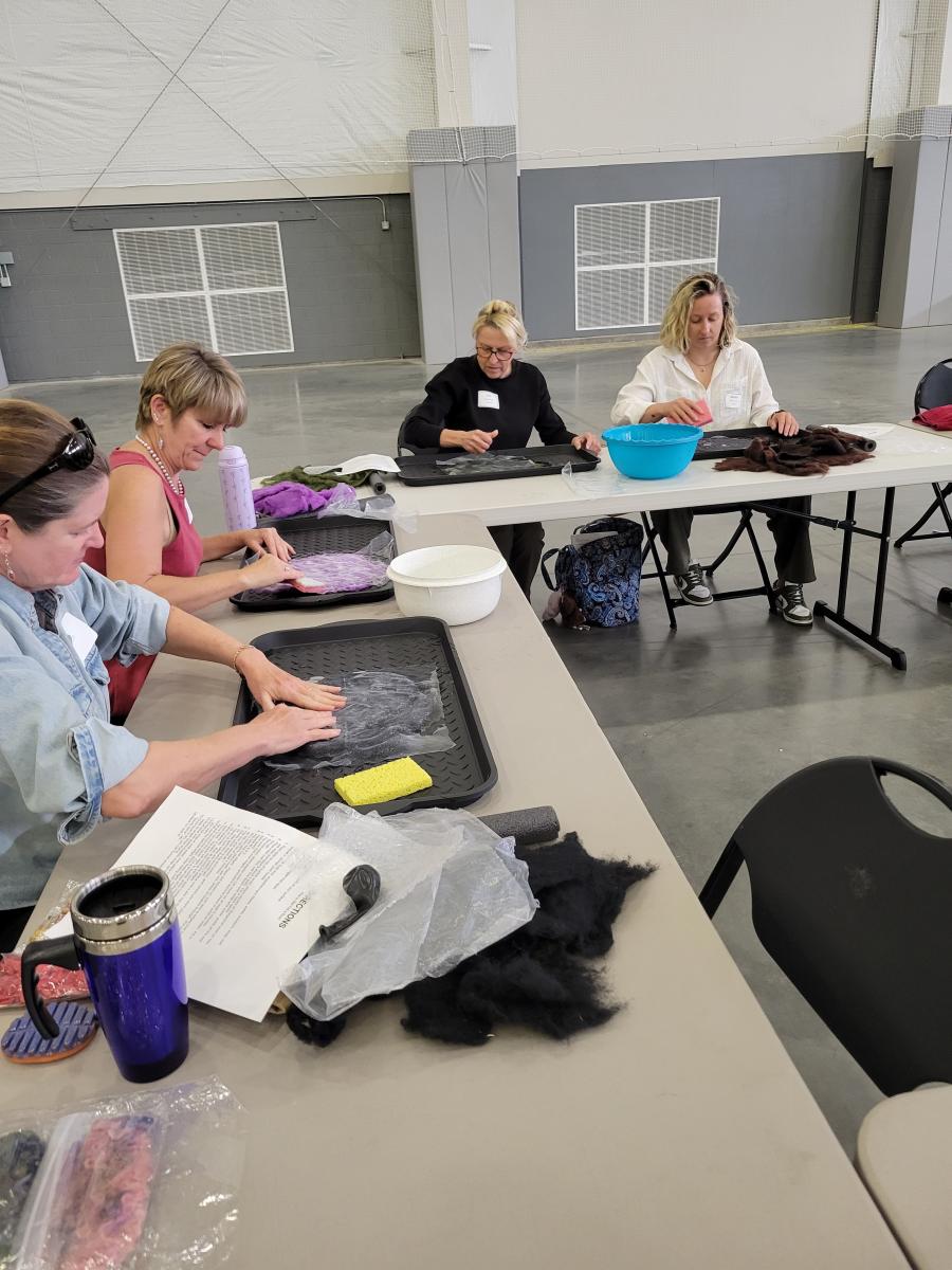 four women working on a wet felting class project