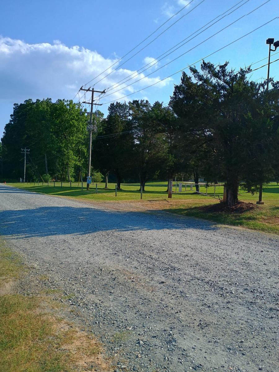 Gravel road in between both fields. Customers can park down at the end of the road.
