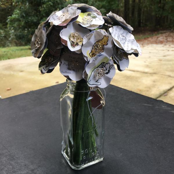 Eeyore has a birthday hand-cut paper flower arrangement in a clear honey bottle