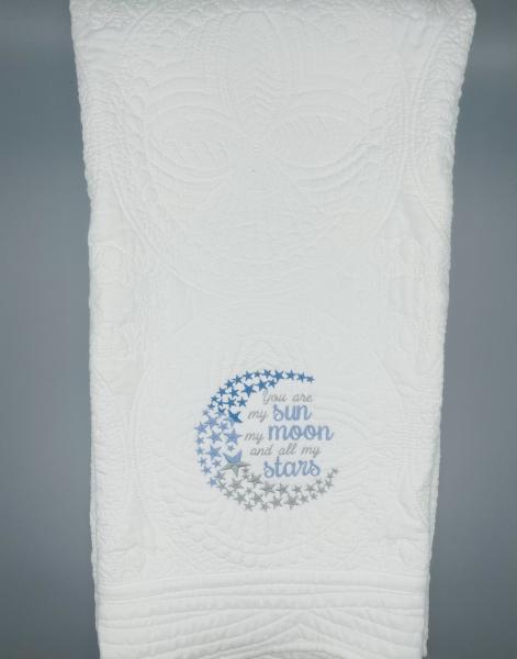 Embroidered moon baby quilt