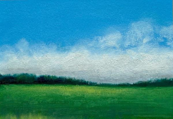 Blue skies over green fields