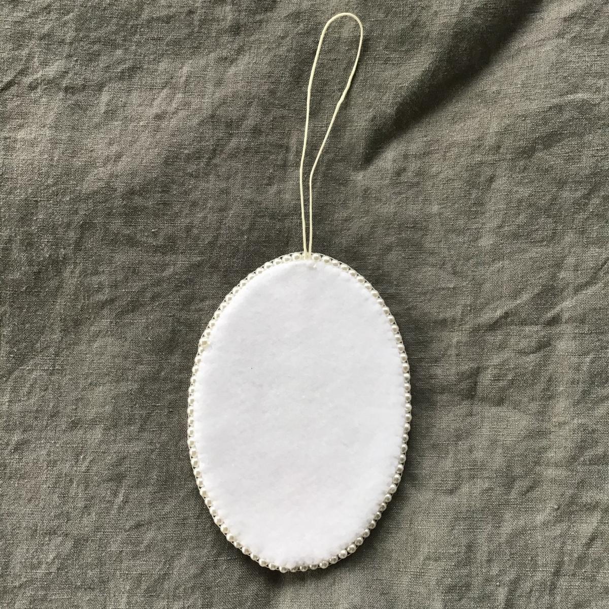 Tangled Hair Oval Raccoon Ornament picture