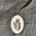 Tangled Hair Oval Raccoon Ornament