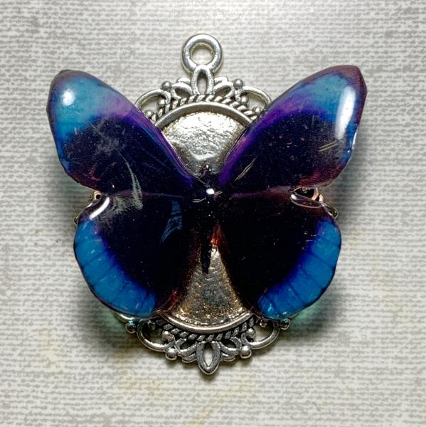 Black, blue, and purple resin butterfly pendant
