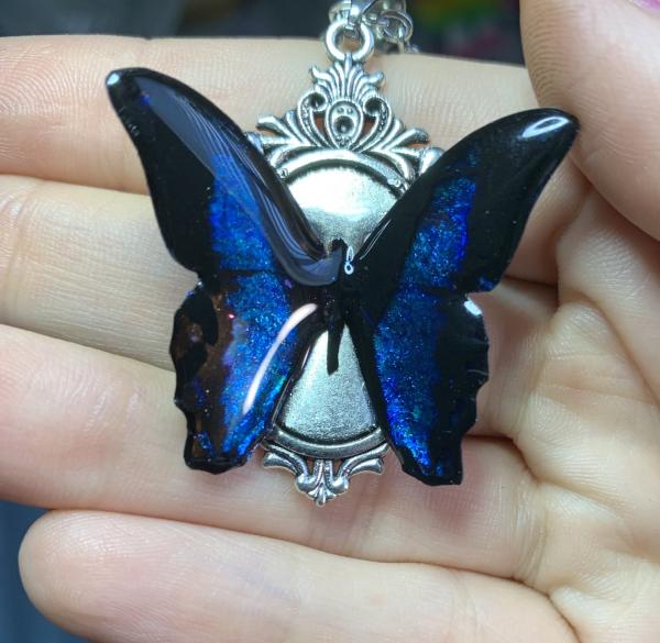 Black and iridescent blue butterfly pendant