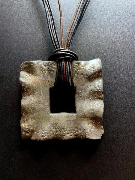 Square Raku Ceramic on Brown and Black Leather picture