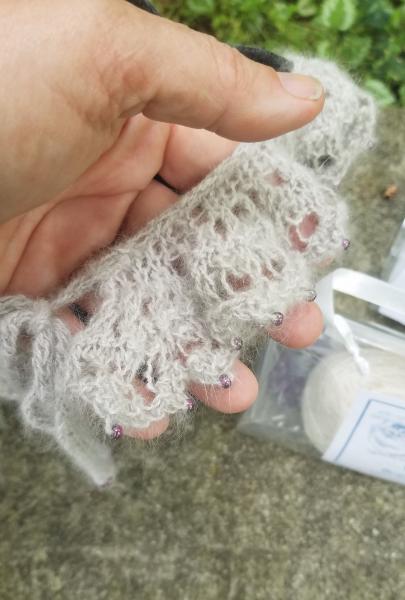 This is a kit to create this knitted lace beaded collar. (The knitted example is a different color from the yarn in this kit.) The collar can be worn picture