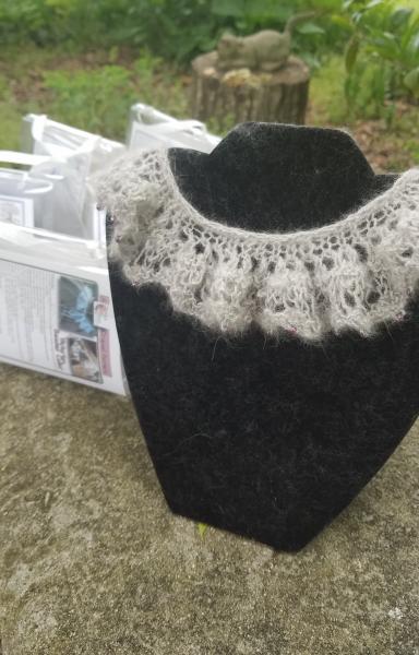 This is a kit to create this knitted lace beaded collar. (The knitted example is a different color from the yarn in this kit.) The collar can be worn picture
