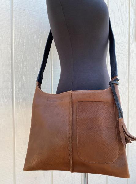 Crossbody, Brown leather with black strap and Exterior pocket (zipper) picture