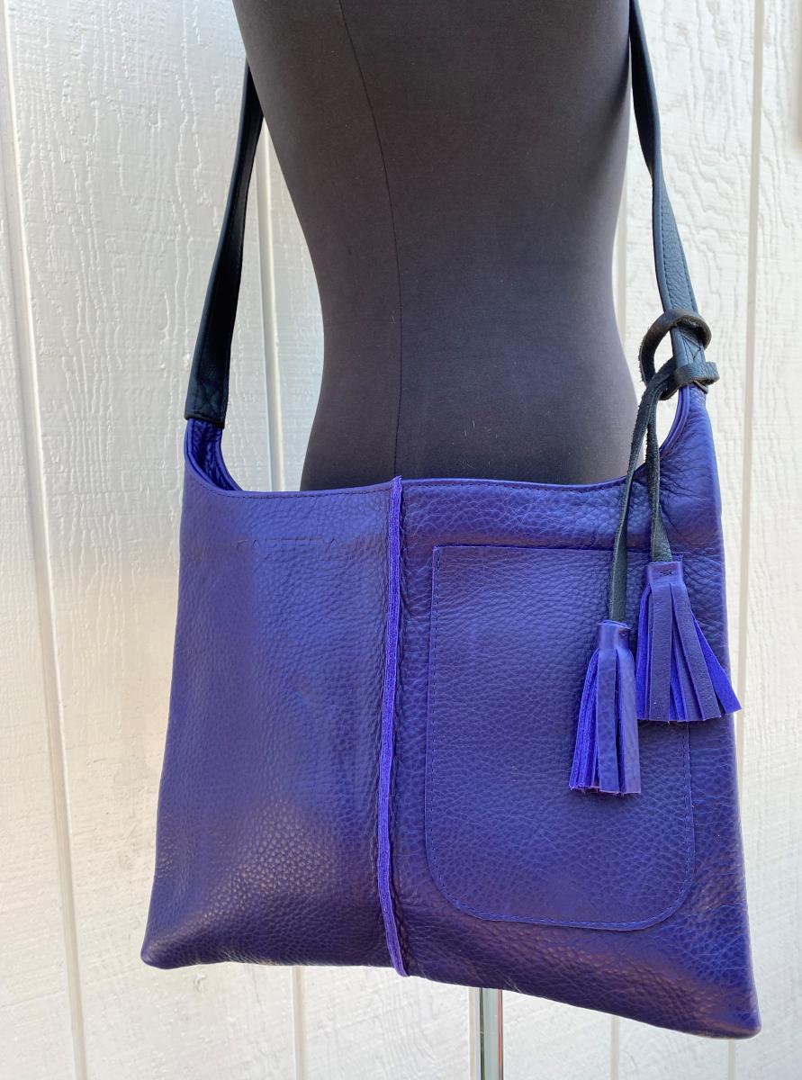 Crossbody, Purple leather with black strap and Exterior pocket (zipper) picture