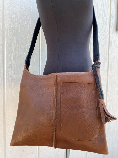 Crossbody, Brown leather with black strap and Exterior pocket (zipper) picture