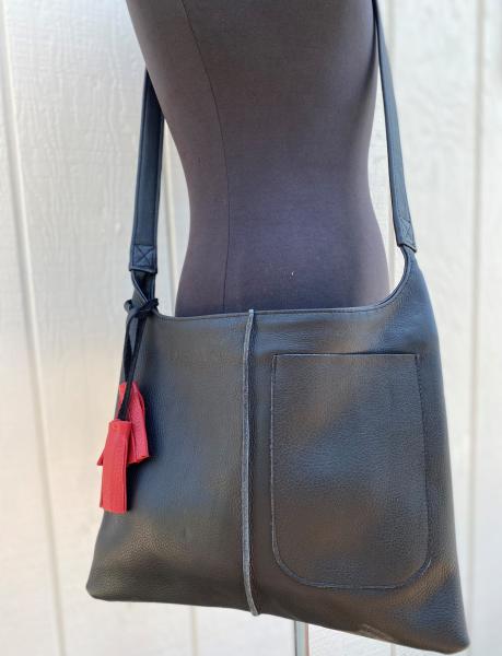 Crossbody, Black leather with black strap and Exterior pocket (zipper) picture
