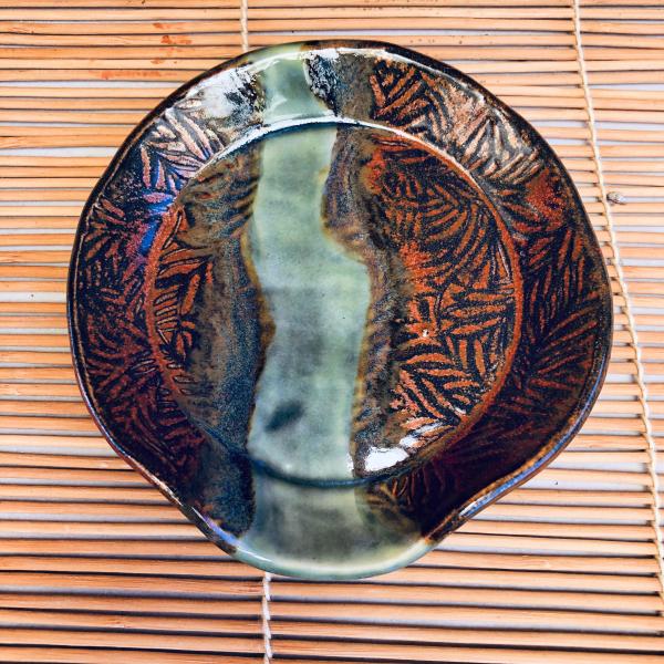 Ceramic spoon rest with gorgeous copper edges and colorful strip in the center.