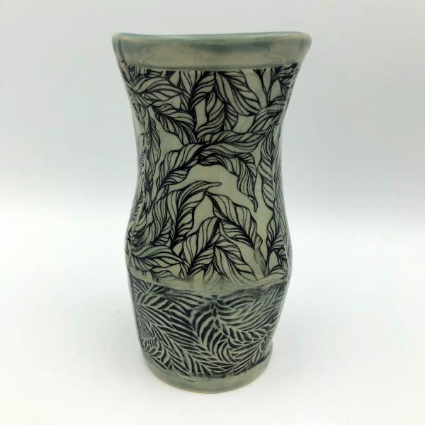 Ceramic vase with subtle gray green glaze over leaf imagery and texture picture