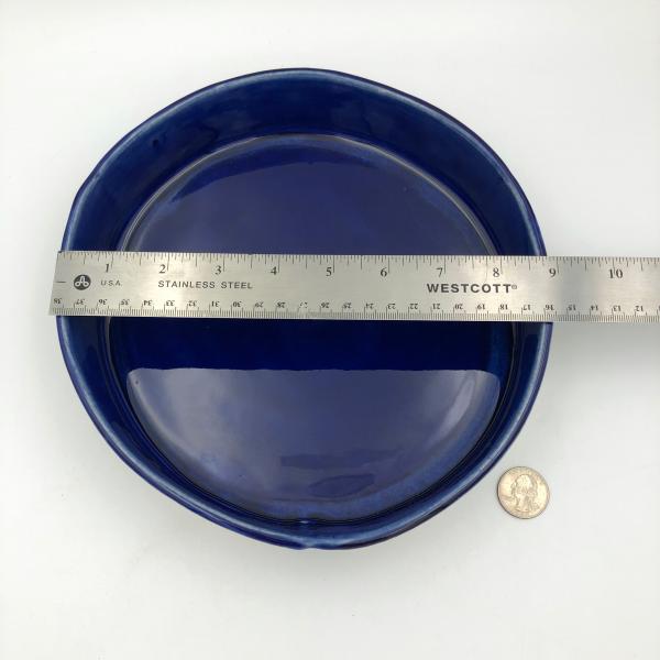 Handbuilt cake pan with rich cobalt glaze inside and blue floral pattern outside. picture