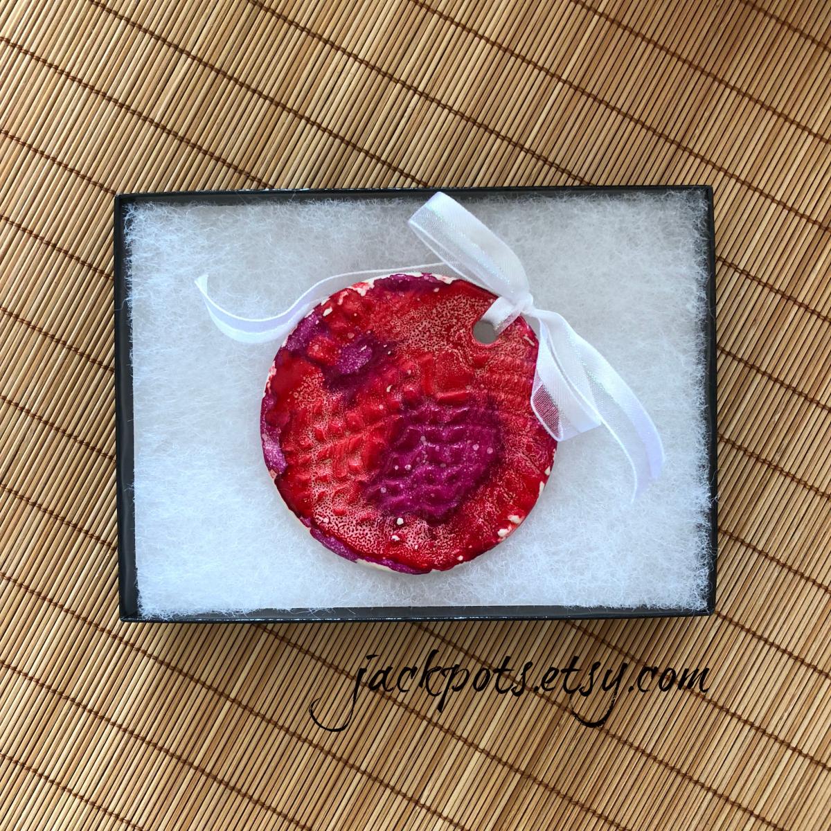 Handmade ceramic Christmas ornament embellished with alcohol ink painting. picture