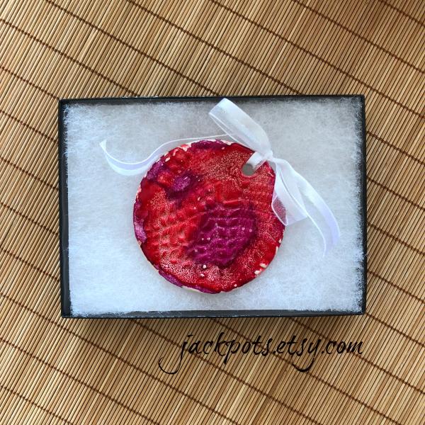 Handmade ceramic Christmas ornament embellished with alcohol ink painting. picture