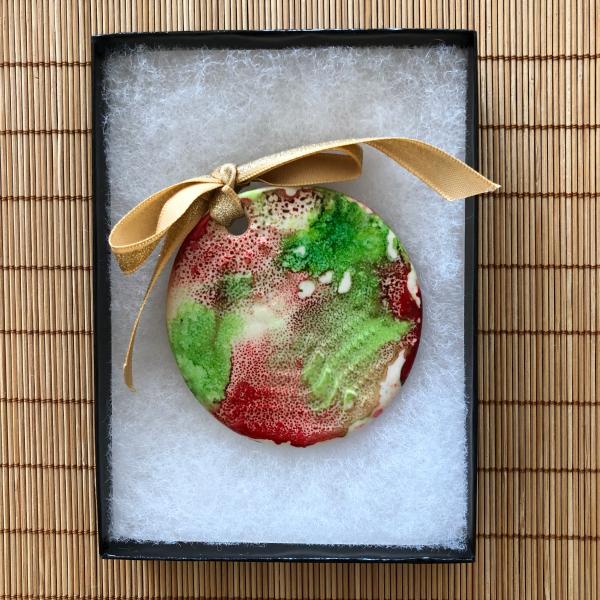 Handmade ceramic Christmas ornament embellished with alcohol ink painting. picture
