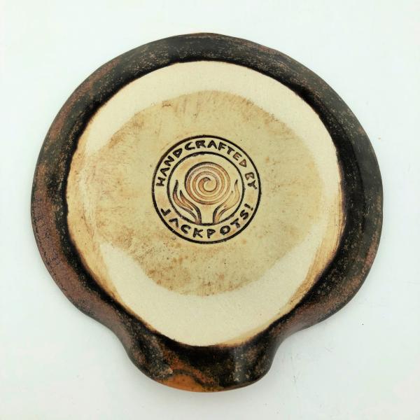 Ceramic spoon rest with gorgeous copper edges and colorful strip in the center. picture