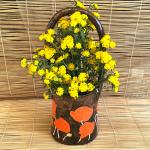 Large ceramic basket vase with bright orange poppies and shiny copper glaze