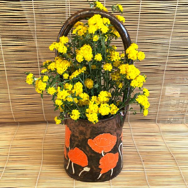 Large ceramic basket vase with bright orange poppies and shiny copper glaze picture