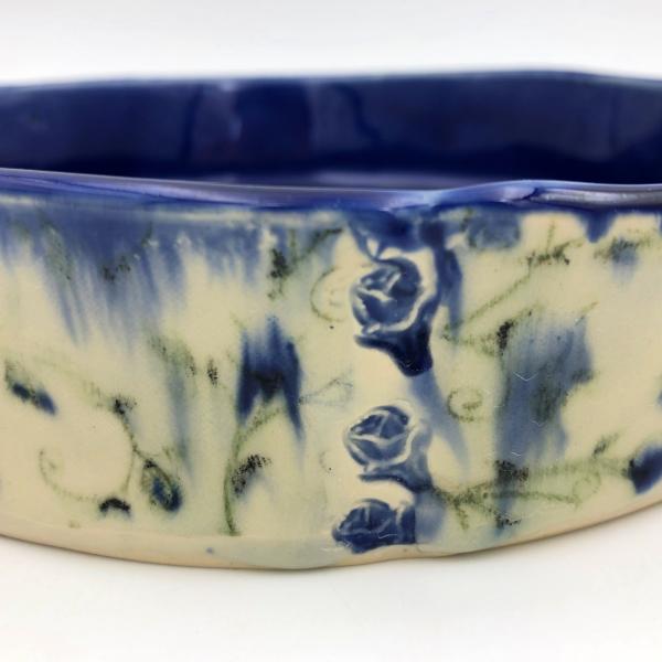 Handbuilt cake pan with rich cobalt glaze inside and blue floral pattern outside. picture