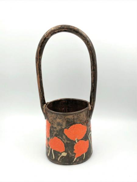 Large ceramic basket vase with bright orange poppies and shiny copper glaze picture
