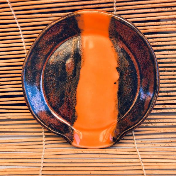 Ceramic spoon rest with gorgeous copper edges and colorful strip in the center. picture