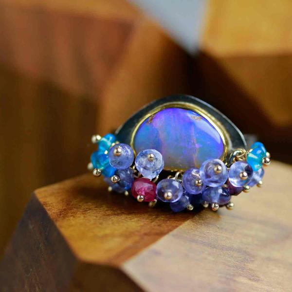 Queensland Pipe Opal with Undersea Ridges and Tanzanite Fringe. Ring Size 8 1/2.