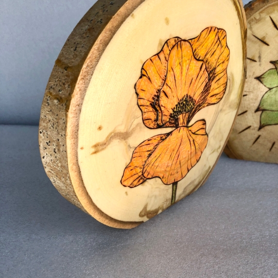 Flower and succulent wood burned art on stand-up tree slices picture