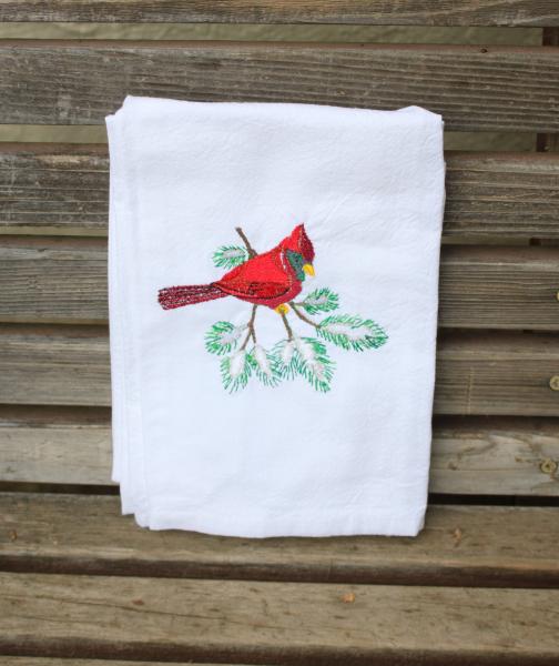 A red winter cardinal on a pine branch embroidered on a white flour sack tea towel, dish towel, cotton