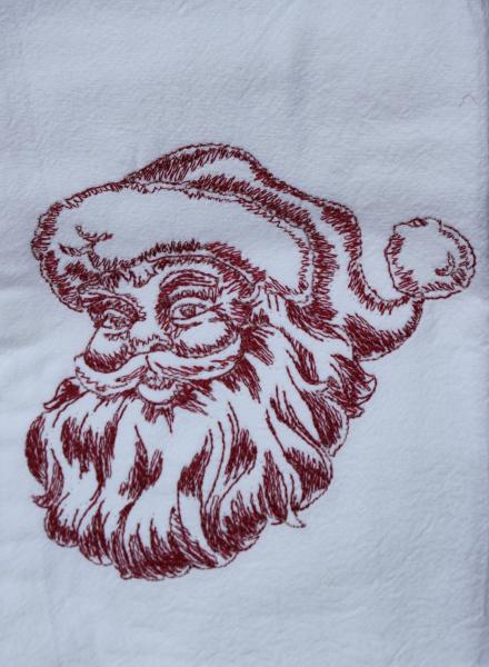 A Beautifully drawn Santa is embroidered on a white flour sack tea towel, dish towel, cotton picture