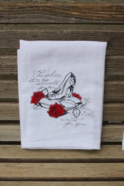 A Beautifully drawn stylized Cinderella glass slipper is embroidered on a white flour sack tea towel, dish towel, cotton