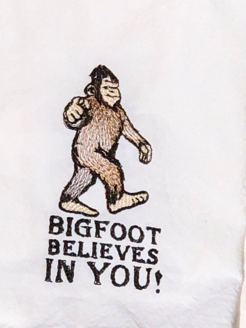 Bigfoot believes in you is embroidered on a white flour sack tea towel, dish towel, cotton picture