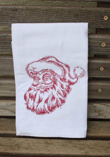 A Beautifully drawn Santa is embroidered on a white flour sack tea towel, dish towel, cotton