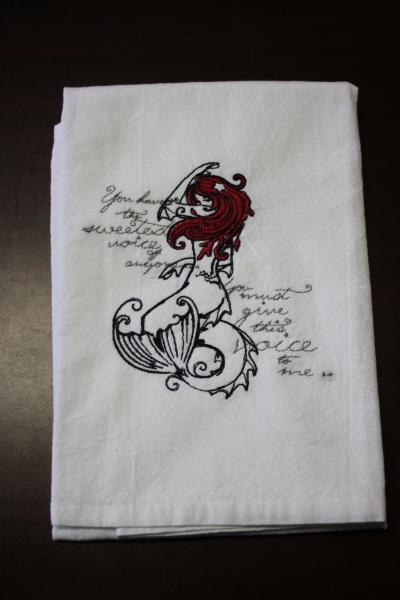 A Beautifully drawn stylized Little mermaid is embroidered on a white flour sack tea towel, dish towel, cotton picture