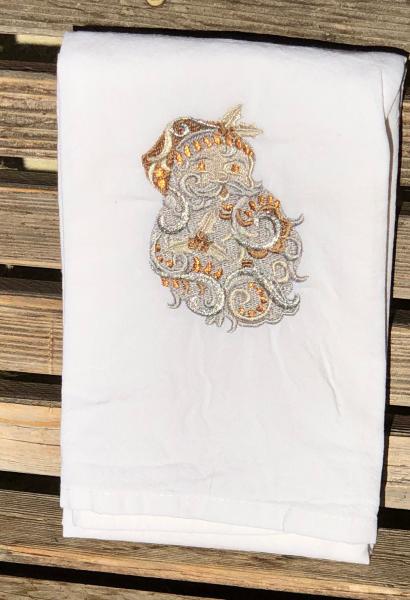 A Christmas Santa is embroidered on a white flour sack tea towel, dish towel, cotton