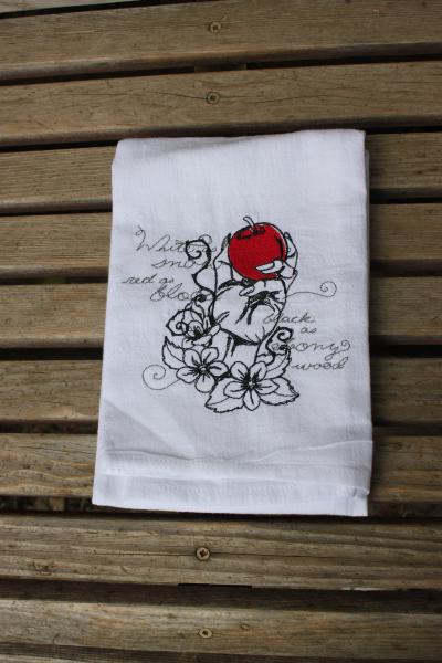 A Beautifully drawn stylized Snow white poison apple is embroidered on a white flour sack tea towel, dish towel, cotton