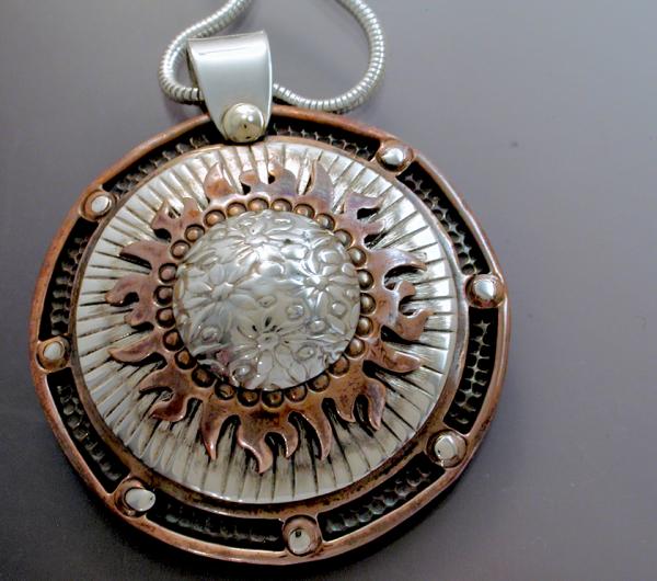 Multi level silver & copper sun pendant