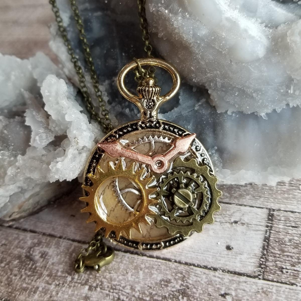 Steampunk Gold, Copper, Silver & Antique Bronze Gears in Resin in Vintage Watch Shaped Pendant picture