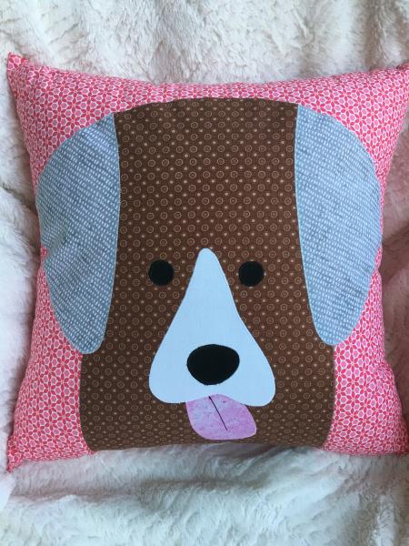 Brown dog on pink and white background pillow
