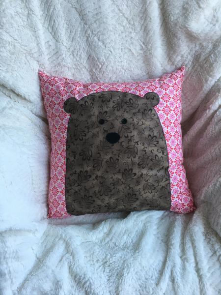 Brown bear appliqué on pink/white pillow