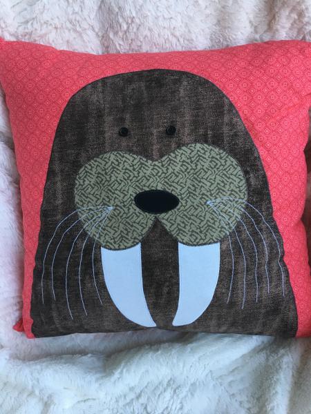 Walrus appliqué on coral background pillow